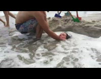 Girl buried in sand wave washes over 