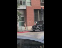 Brown trench coat dress girl poses sidewalk 