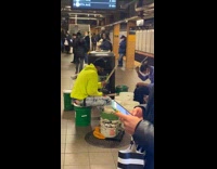 2 people play drums fast on buckets 