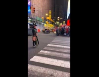 person in witch hat poses in the middle of street new york