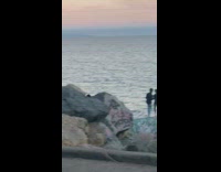 Guy black jacket stand pose ledge shore 