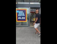 Dad wears baldi shirt next to aldi sign