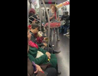 Man with fake red fish bag sings on subway train