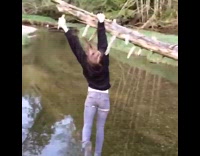 Brunette lady tree grab above lake fail slomo 