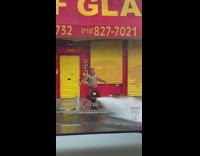 Red shorts guy water broken fire hydrant 