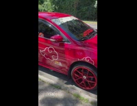 Red car with anime sticker 
