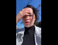 Woman shows ducks on street 