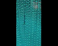 Woman dance between hanging string light bulbs