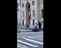 Man shirtless strong pose in front of bull statue