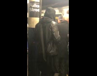 Guy in Hoodie Wears Samurai Sword in Subway Terminal