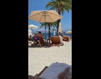 Woman beach chair under umbrella sip drink