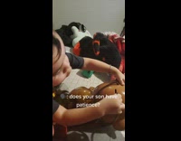 Little boy struggles with coin jar toy 