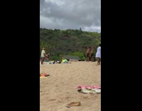 Two guys black shorts lift dumbbells beach