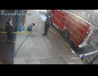 Woman on sidewalk walks under hose instead of stepping over