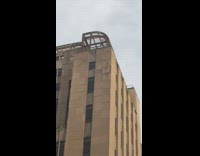 Peaceful protest guy brown building cheers waves