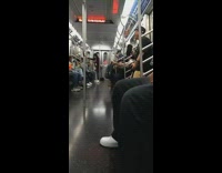 Man holding portable speaker dancing on subway