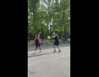 Two guys pass soccer ball to each other 