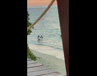 Shirtless guy poses ocean water white boat 