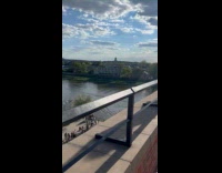 Woman white skirt poses edge of wall Part 1