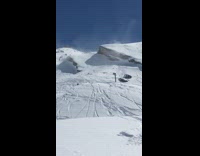 Skier does a big jump off hill, triple backflips and crashes into snow