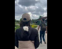 Woman walk at park white cat on hoodie