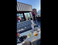 Woman bucket hat poses for balcony photo