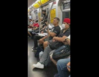 Guy uses muscle massaging machine on train 