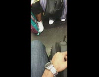 Man in crown gold chain and jewelry on subway train