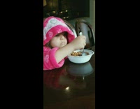 little girl angry while eating cereal 