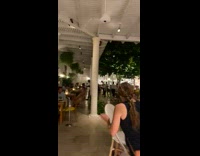 Little kid falls off chair at outdoor restaurant 