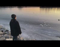 Girl throws chunk of ice in reverse slow motion