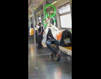 Guy rides train with two green rings 