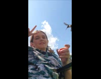 Kid holding feeder for hummingbird 