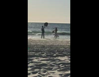 Woman white dress arms and feet up beach