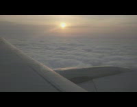 Airplane fly over sea of clouds sunset