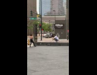 Guy white shirt squat peace sign street