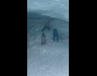 Friend throw snow on shirtless man in cave part 2