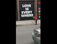 Red sweater love sign camera self timer