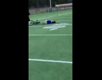 Guy flips falls off bike on football field