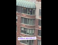 Man clean building window without safety harness