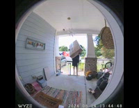 Delivery man brings large box on porch