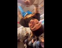 Guys perform on subway hangs in rails