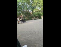 Black shirt guy sits park bench sings