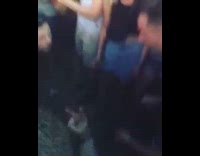 Two guys play rock paper scissors at music festival 