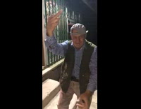 Old man puts up the middle finger and holds gun up high