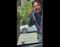 People arguing causing traffic in middle of street