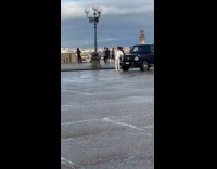 Man poses beside the black luxury car