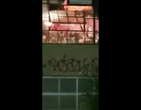 Shirtless guy waves sword around inside apartment