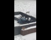 Guy lays on couch hugs huge snowball