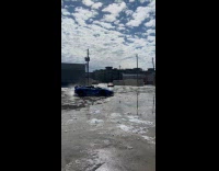 Blue sports car drifts around the snow